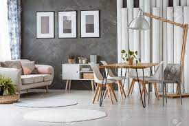 You will love it even more after seeing this list. Bright Dining Room With White Plastic Chairs And Relax Space With Beige Couch And Pink Cushions Stock Photo Picture And Royalty Free Image Image 93533109