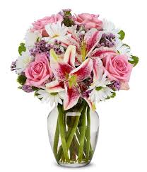 This luxury white lilies bouquet features pops of color with whisper soft pink carnation blossoms and rose selections. Shining Roses And Lily Joy At From You Flowers