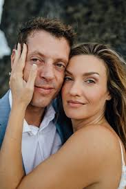 Share this wedding photo list with your photographer to make family photos and portraits on your wedding day a smooth experience. A Couple Took Photos In The Ocean Wearing Full Wedding Attire