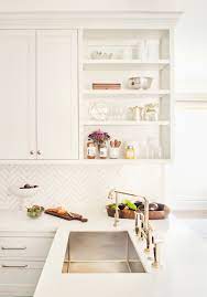 Check out these arctic white quartz countertops compliment by a muted, teal wall and a burst of white cabinets. Remodeling 101 7 Things To Know About Engineered Quartz Countertops