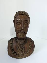ID please. I have tried Google Lens but I haven't been able to find  anything to help me identify the age or artist of this wood carved piece. I  am also trying