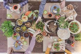 Veganism has skyrocketed in popularity and it's easy to see why; Friends Sitting At Rustic Table Having Vegetarian Dinner Party Stock Photo Picture And Royalty Free Image Image 68548723