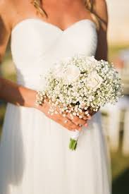 These delightful baby's breath tin can streamers is another easy diy idea for hanging wedding decor.{diy tip} created by jesi haack and snapped by studio emp, all you need are empty and clean tin cans, which can be filled with small bouquets of baby's breath and then secured to metal chains that are hung up.these tin cans can also be wrapped in burlap, lace and tied with twine. Baby S Breath Bouquet And Blush Pink Roses Summer Wedding In Chania Crete Simple Wedding Bouquets Babys Breath Bouquet Bridesmaids Simple Bridesmaid Bouquets