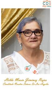 Conozcamos a nuestras candidatas al reinado parroquial. El día de hoy  presentamos a: Sra. Hilda Jiménez Rojas. Edad: 74 años Comunidad: Nuestra  Señora de los Ángeles. Doña Hilda, es casada con don