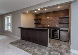 And we love it too! Modern Rustic Farmhouse Basement Bar With Floating Shelves And A Wood Accent Wall Rustic Basement Basement Bar Designs Home Bar Designs