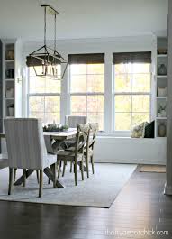 Layered rugs beneath the table help delineate the dining area, while pastel walls make the room feel more expansive and inviting. Dramatic Dining Room Makeover Thrifty Decor Chick