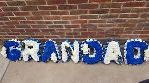 Superb value traditional flowers for funerals, floral tributes, sympathy flowers, funeral white lily sympathy bouquet from arena funeral flowers uk. Blue White White Based Grandad The Village Florist