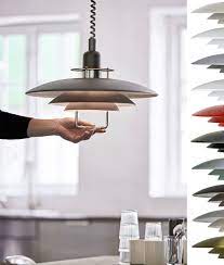 Handmade italian 'rise and fall' pendants featuring a white murano glass shade suspended by a ceramic or aged brass counterweight. Scandinavian Metal Rise Fall Modern Pendant Light