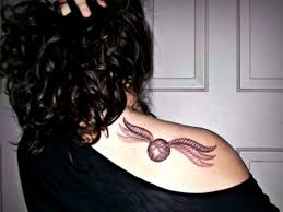 This boy believes in the strength and virtues of united action and has got a cool tattoo on his arm to express the same. Awesome Harry Potter Snitch Tattoo On Girl Right Back Shoulder