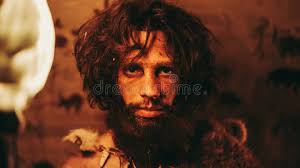Portrait of Primeval Caveman Wearing Animal Skin Standing in His Cave at  Night, Holding Torch with Stock Image