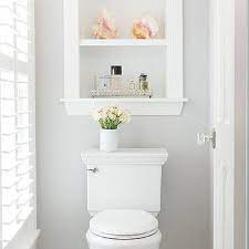 Two doors keep toiletries hidden away on two shelves, while an open shelf provides storage and display space. Recessed Shelves Above Toilet Design Ideas