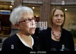 A tear rolls down Merry Jackson's cheek as she talks with reporters at the  Legislative Office Building before speaking at a public hearing by the  Judiciary Committee