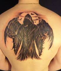 Cross tattoos can definitely vary in design. Dark Black Ink Angel Of Death With Skull Cross Tattoo On Full Back