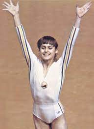 She was the first gymnast to be awarded a perfect score of the 10.0 at the olympic games at the age of 14 years, where she also received six more perfect to winning three gold medals in the same game. Nadia ComÄƒneci Wikipedia