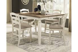 Four chairs are comfortably upholstered in faux leather for easy cleanups. Realyn Counter Height Extendable Dining Table Ashley Furniture Homestore
