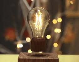 The light bulb levitates itself as opposing forces on both magnets repel each other. Home Garden Light Bulbs Magnetic Levitating Light Bulb Desk Wood Grain Floating Lamp