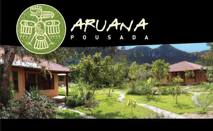 Estrutura central e acolhedora da Pousada Aruana, gerada com IA