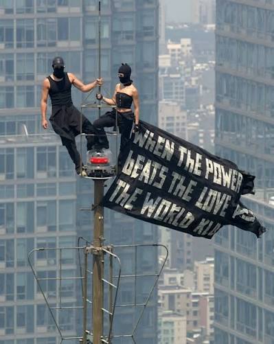 Heart stopping moment high above Manhattan. Professional urban explorers Angela  Nikolau and Ivan Beerkus climbed to the top of the Empire State Building  spire and unfurled a black banner with a message