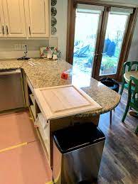 The kitchen is a smaller kitchen and when the home was built they probably wanted to put as many cabinets in as they could for storage. How To Convert A Kitchen Desk Into Pull Out Trash Average But Inspired