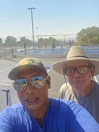 Volunteers clean pickleball courts