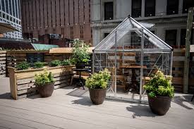 Plastic benches held up by concrete blocks make a simple benching. Dine In Private Greenhouses At This Manhattan Rooftop Restaurant