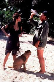 A woman carrying her dead husband's casket in a ship finds herself shipwrecked on an island with a drunken sailor. Trouble In Paradise 1989