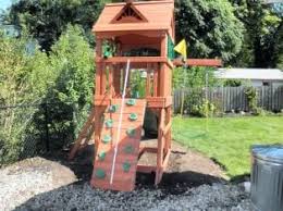 Easy to assemble and small enough to fit in a small backyard, this set also promises to last for a long time thanks to the quality of the components. Swing Sets Assembly And Installation Nj Backyard Playset Backyard Playground Playground Backyard Diy