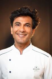Vikas Khanna poses with 'kingmaker' Rick Smilow in his new NYC restaurant