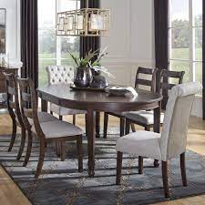 From matching dining chairs to consoles and buffet tables to bar carts, you'll find all the pieces you need for your space. Signature Design By Ashley Adinton 7 Piece Oval Dining Set In Reddish Brown Nebraska Furniture Mart