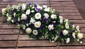 Casket spray purple and white funeral flowers. Purple And White Coffin Spray Funeral Flowers Florists Funeral Tributes