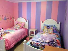 In this fashionable living room, custom blue paint sets the foundation for an unexpected mix of patterns and unique decorative accents. Room For Twin Girls One Wall Is Pink And One Purple One Wall Has The Stripes And The Wall You Can Purple Girls Room Purple Girls Room Paint Girls Room Paint