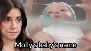 In "Christmas In Connecticut," we're told the baby's name is Roberta. After  her bath, the sailor calls her Molly.