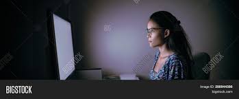 When you're working in a dark or dimly lit room, reduce the brightness on your monitor. Computer Online Image Photo Free Trial Bigstock