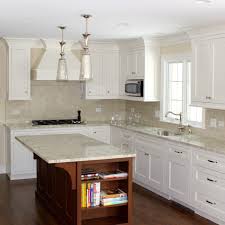 White farmhouse sink with granite countertops and chocolate cabinets. 5 Timeless White On White Kitchen Looks
