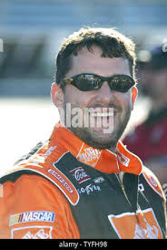 Race car driver Tony Stewart, center, takes a shot during a basketball game  at the Carmelo Anthony Center at Syracuse University in Syracuse, N.Y.,