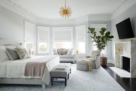 Bay windows bring a unique style element to a room and a home. Bed In Front Of Bay Window Design Ideas
