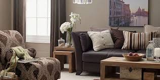 The white sofa paired with a wood coffee table, wicker pouf, beige rug, and blue patterned armchair. Coffee Table Design Ideas And How To Choose Yours