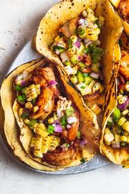 Try this delicious fish taco recipe with mango salsa and queso fresco that are rubbed down with herbs and spice. Spicy Shrimp Tacos With Charred Corn And Mango Salsa Is The Perfect Summer Recipe For A Crowd Grab This Fiery Swe Spicy Shrimp Tacos Spicy Shrimp Mango Salsa