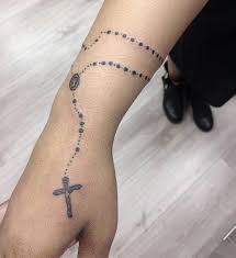 Tribal cross tattoo designs are a symbol of honor, life, and hope. Minimalistic Rosary Tattoo Around Wrist 0 Fullsleevetattoos Full Sleeve Tattoos Sleeve Tattoos Rosary Tattoo