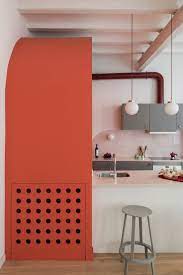 The Living And Dining Area Is Dominated By A Coral Coloured Arched Volume That Conceals The Guest Toilet Coral Interior Interior Contemporary Interior Design