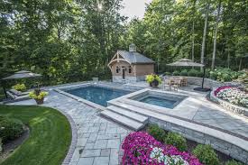 Learn how to enhance your pool with landscaping features such as planters, waterfalls, shade structures and more. Swimming Pool Landscaping Pretty With A Minimum Of Debris