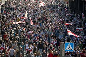 Protesters hold a huge former belarusian flag during an opposition rally staged by senior citizens in central minsk, nov. March Of 100 000 Defy Police Crackdown To Mark Week 7 Of Belarus Protests The Times Of Israel