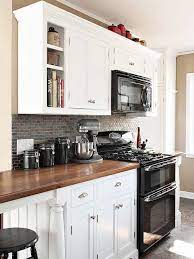 Caesarstone quartz countertops provide a traditional granite look with its cool, dark gray base accented with strokes of black and white. Update Your Kitchen On A Budget Black Appliances Kitchen Home Kitchens Kitchen Remodel