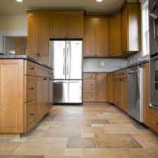 The color of your kitchen floor can set the tone of your room and tie together your kitchen décor. What Colors To Use With Oak Cabinets Ehow Com Best Flooring For Kitchen Maple Kitchen Cabinets Kitchen Flooring