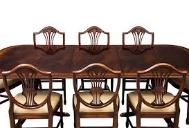 Top rail features figured mahogany veneers and the center of the back of the chair features hand carved solid mahogany details pierced by brass hardware for a unique and high end look. Flamed Mahogany Duncan Phyfe Style High Gloss Dining Table And 8 Chairs Set At 1stdibs