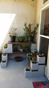 Cinder Block And Wood Plant Shelves Cost Less Than 100 Garden Tips And Tricks Cinder Block Garden Apartment Patio Gardens Patio Garden Design