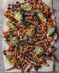 The creamy avocado dipping sauce takes these fries to the next level! Loaded Sweet Potato Fries By Hannah Chia Served With Garlic Tahini Sauce Avocado Parsley Grape T Best Of Vegan