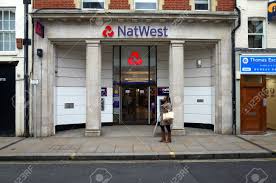 Royal bank of scotland has formally changed its name to natwest group on wednesday, removing the banking group remains headquartered in the city, and the name change will not affect rbs bank. London England February 04 2016 Pedestrian Passing By The National Westminster Bank In Richmond London The