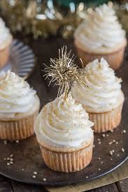 Mini Cupcake Recipes Several Light Colored Cupcakes With White Frosting Decorated With Gold L Cupcake Recipes New Years Eve Dessert Champagne Cupcake Recipes