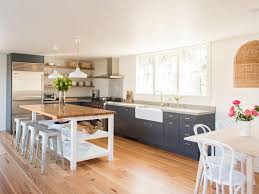 The kitchen area is defined by a small false ceiling structure with linear orange panels. 38 Open Kitchen Dining Areas Chairish Blog